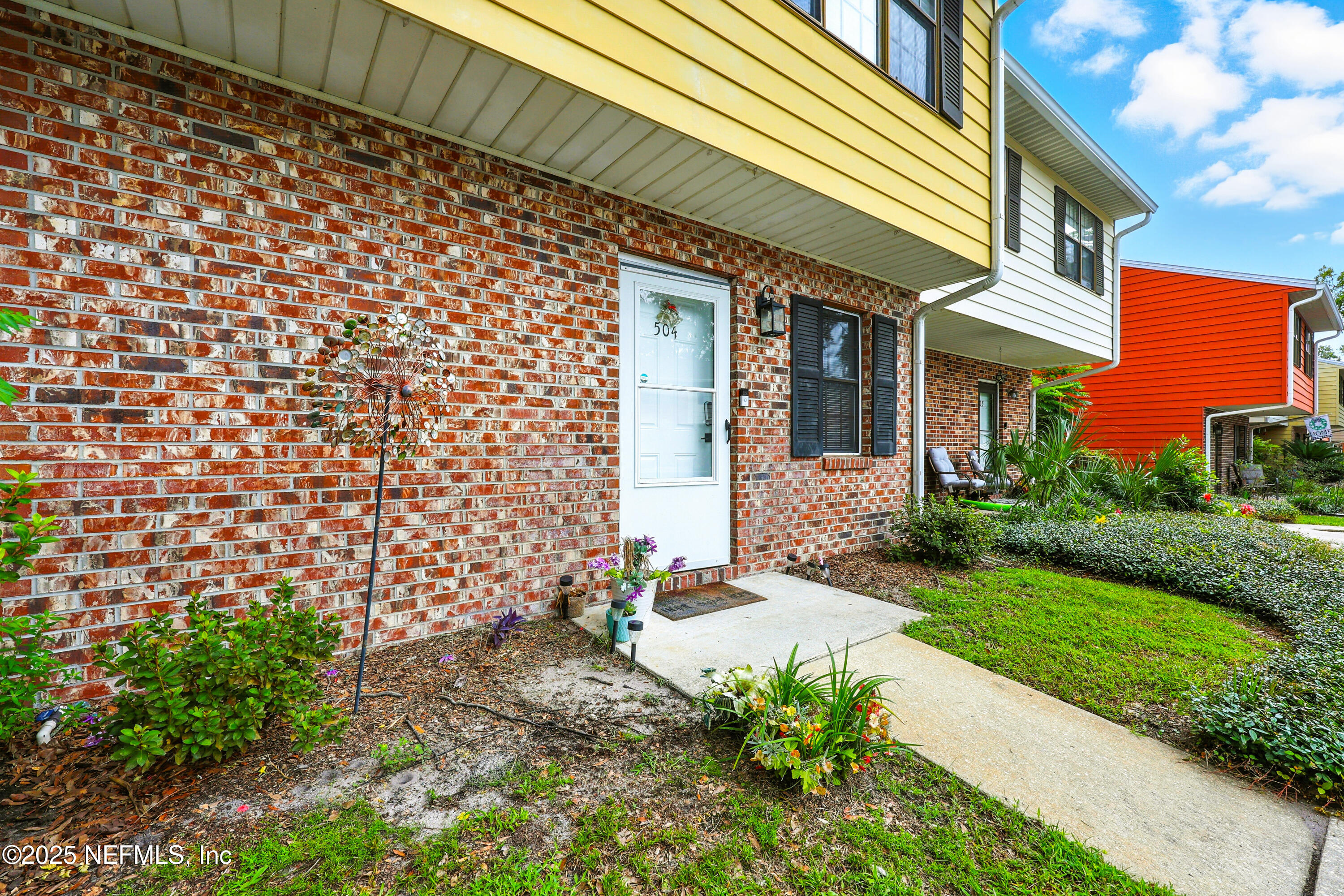 504 Kettering Way Orange Park, FL 32073 - Photo 2 of 27 a front view of a house with a garden