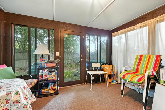 a room with furniture and a floor to ceiling window