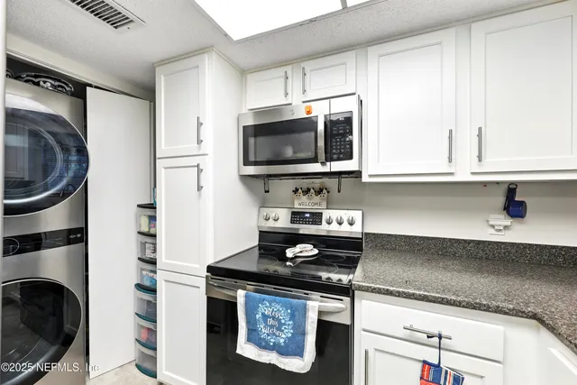 a kitchen with stainless steel appliances granite countertop a stove and a sink
