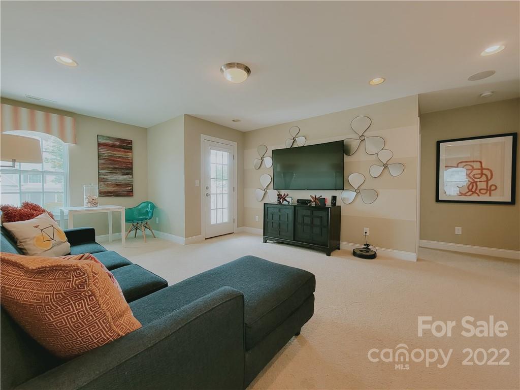 7716 West Berkeley Road Denver, NC 28037 - Photo 20 of 33 a living room with furniture and a flat screen tv