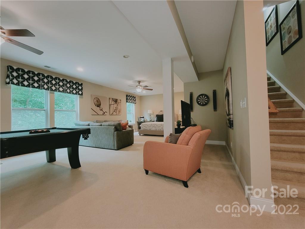7716 West Berkeley Road Denver, NC 28037 - Photo 23 of 33 a living room with furniture a rug and white walls
