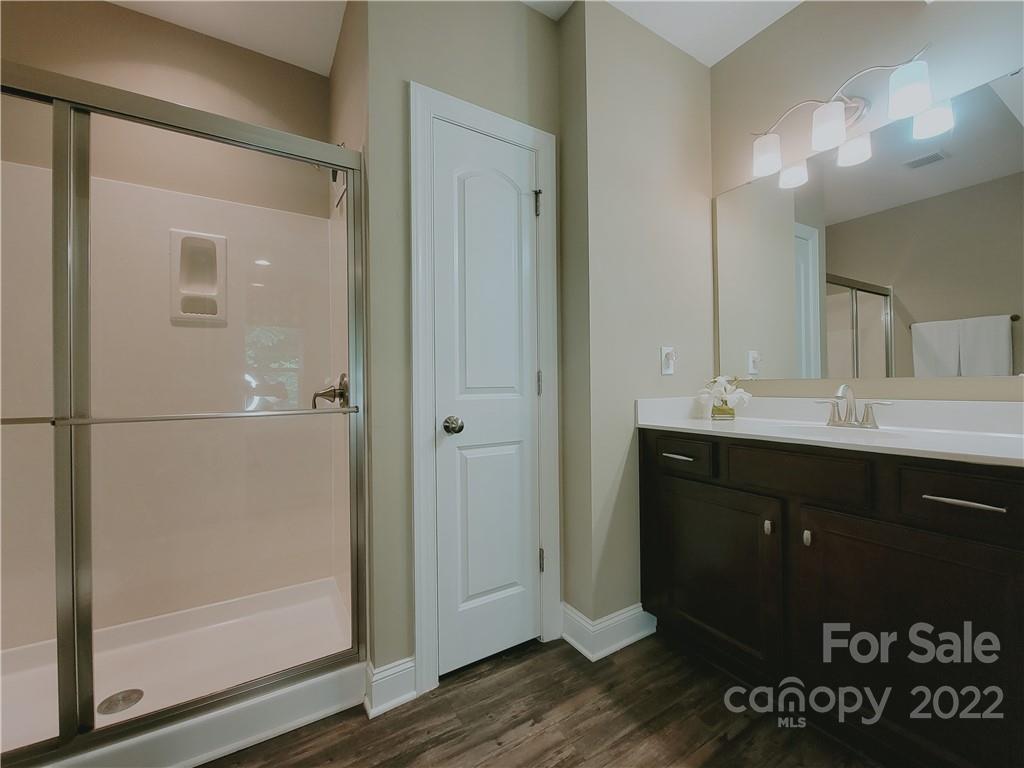 7716 West Berkeley Road Denver, NC 28037 - Photo 27 of 33 a bathroom with a sink vanity and a mirror