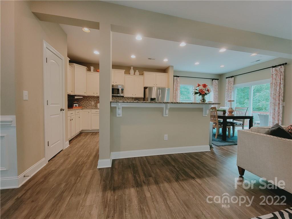 7716 West Berkeley Road Denver, NC 28037 - Photo 4 of 33 a kitchen with a wooden floor and window