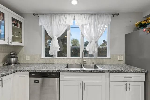 a living room with furniture and a baby crib
