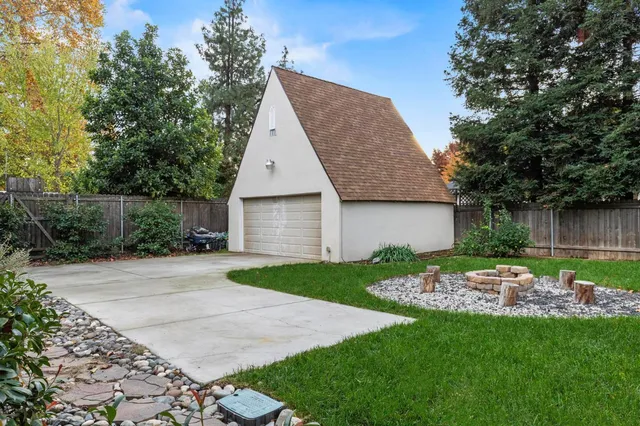 a view of roof deck with chair and tables