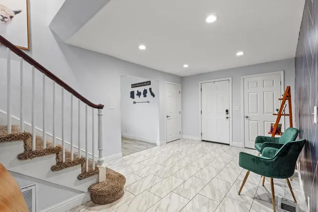 a view of an entryway with wooden floor