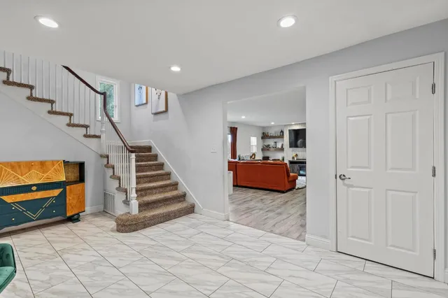 a view of a livingroom with furniture and stairs