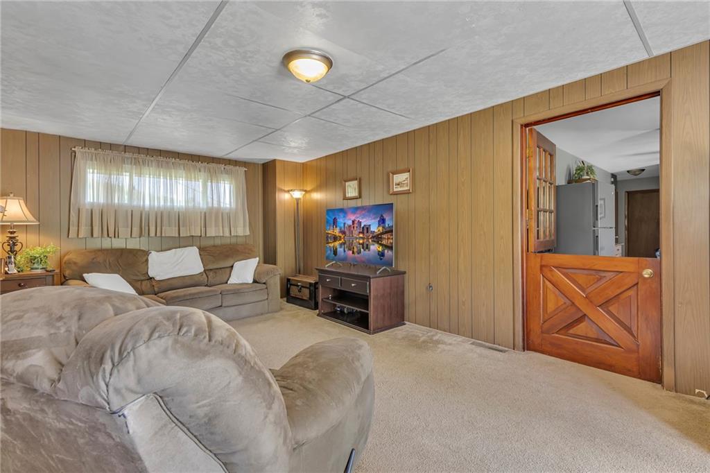 383 Ridgemont Drive Midland, PA 15059 - Photo 26 of 44 a bedroom with a bed and glass windows