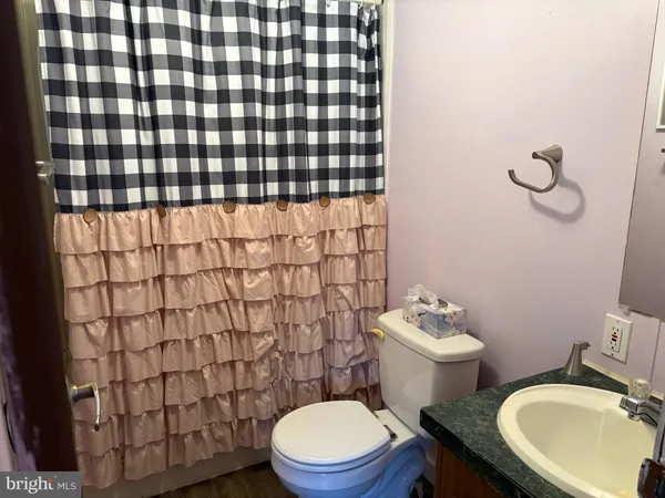 a bathroom with a sink toilet and a mirror