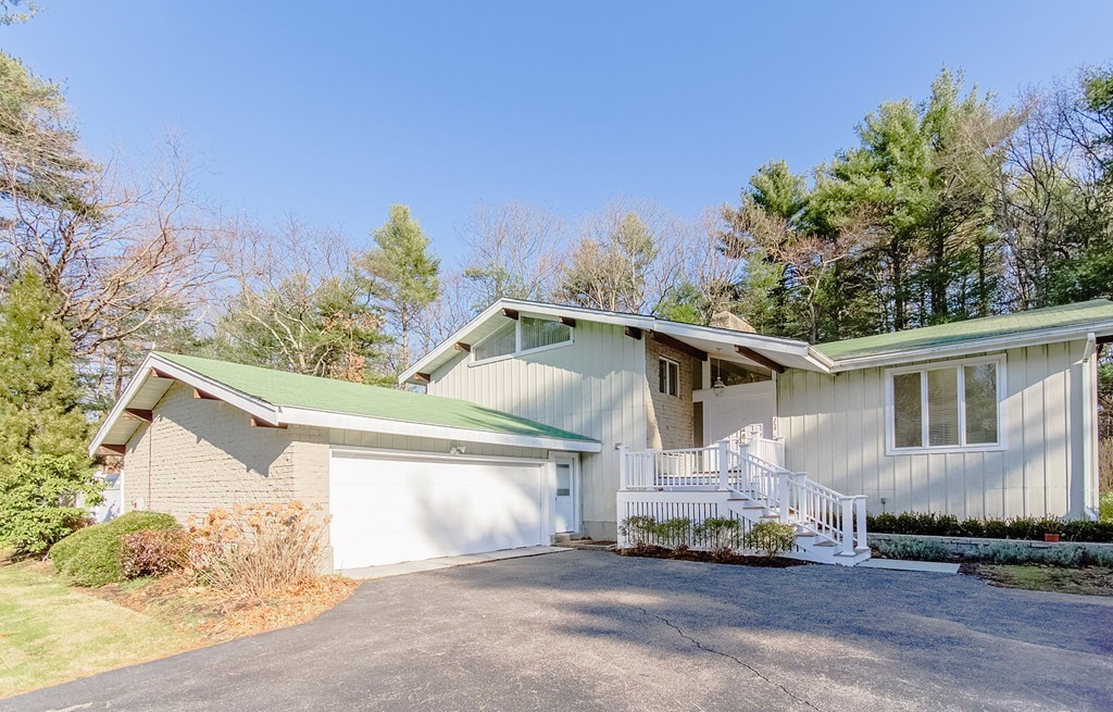 264 Country Way Needham, MA 02492 - Photo 1 of 29 a front view of a house with a yard and garage