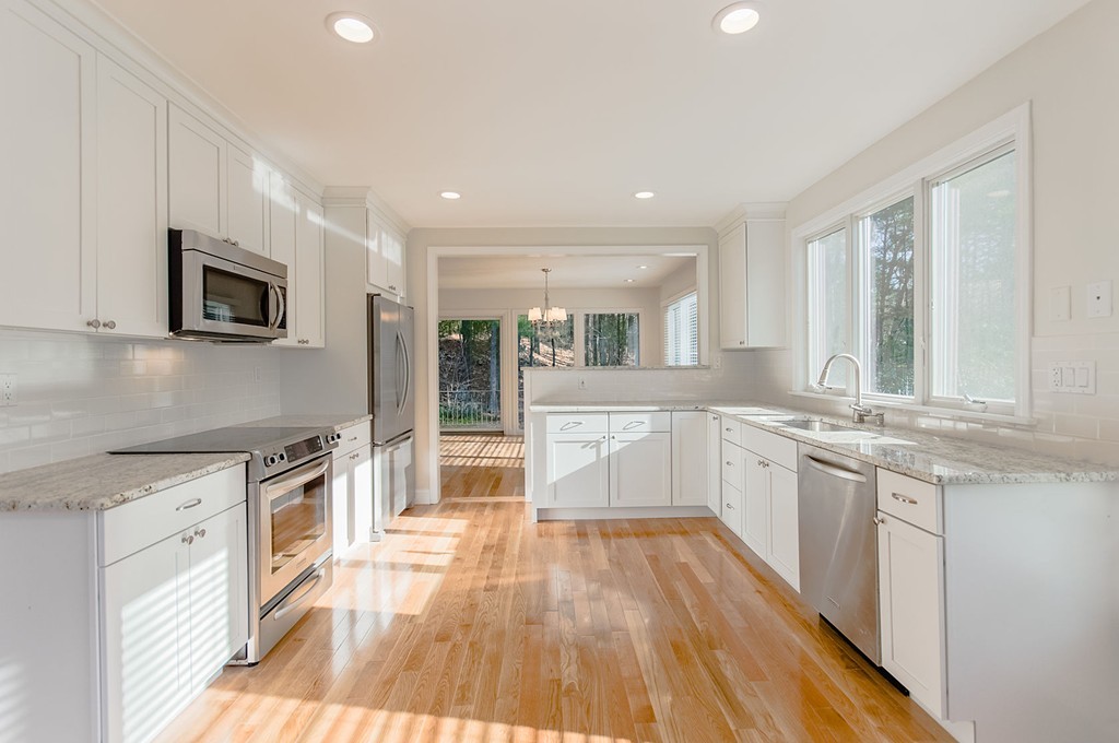 264 Country Way Needham, MA 02492 - Photo 13 of 29 a large kitchen with stainless steel appliances granite countertop a lot of counter space and wooden floors