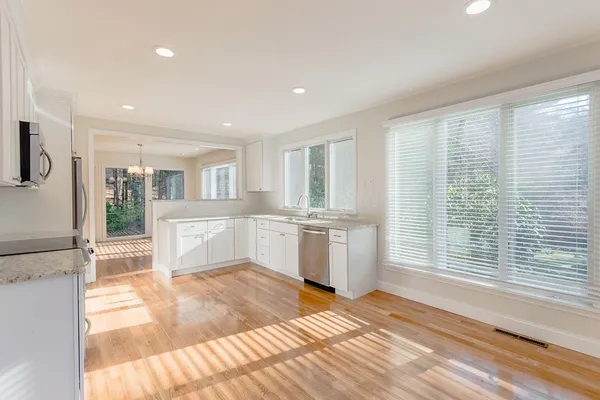 a view of a kitchen with a sink and cabinets