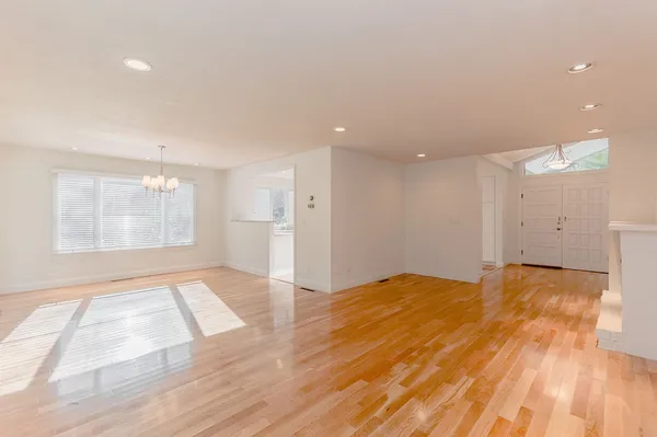 a view of an empty room and wooden floor