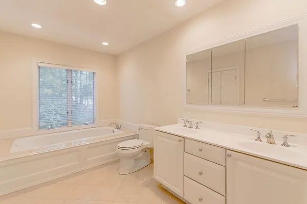 a bathroom with a toilet a sink and bathtub