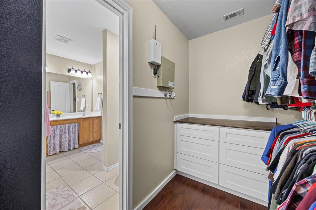 112 Springfield Lane Red Oak, TX 75165 - Photo 21 of 40 a view of walk in closet with clothes and shoes