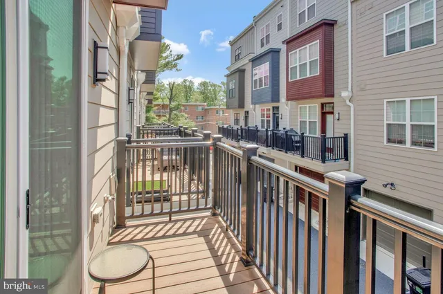 a balcony with two chairs and a table