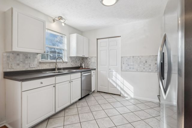 a kitchen with a sink cabinets and appliances