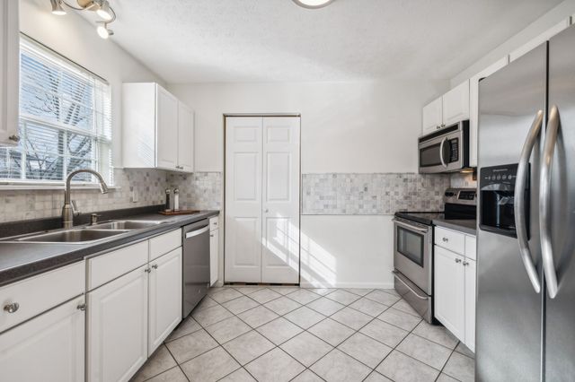 a kitchen with a sink cabinets and stainless steel appliances