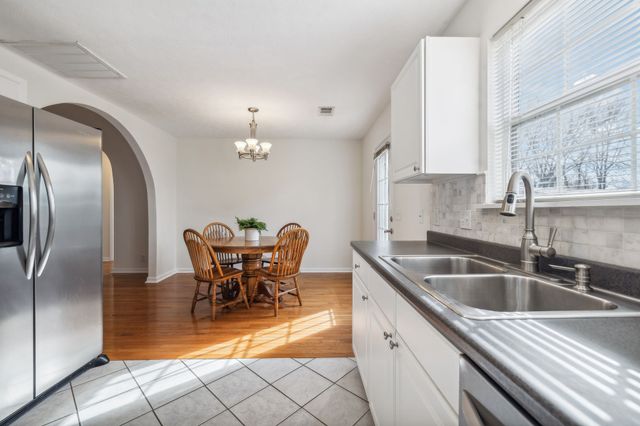a kitchen with stainless steel appliances granite countertop a sink dishwasher and cabinets