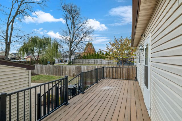 a view of a balcony with wooden floor