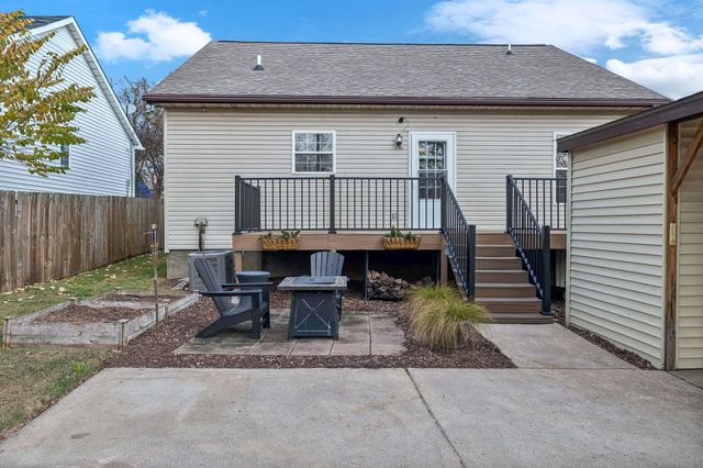 a backyard of a house with table and chairs
