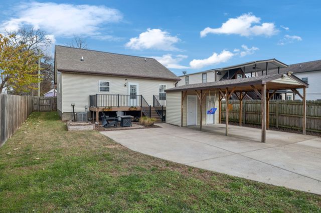 a view of a house with backyard and porch