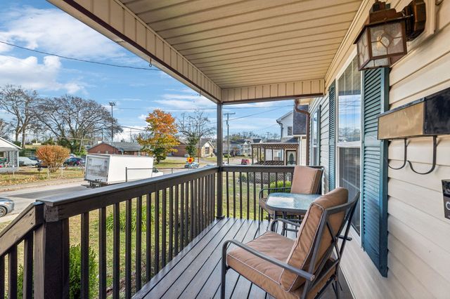 a view of a chairs and table in the balcony