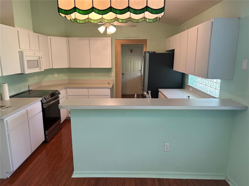 11014 Southwest 73rd Circle Ocala, FL 34476 - Photo 15 of 25 a kitchen with a refrigerator and a sink