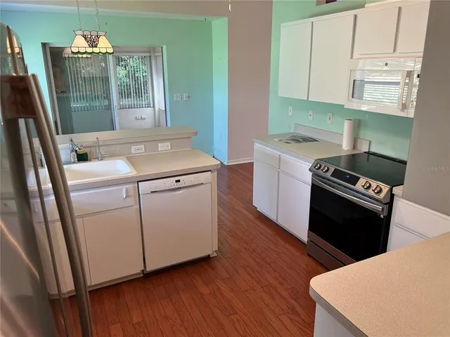 a kitchen with a stove and a refrigerator