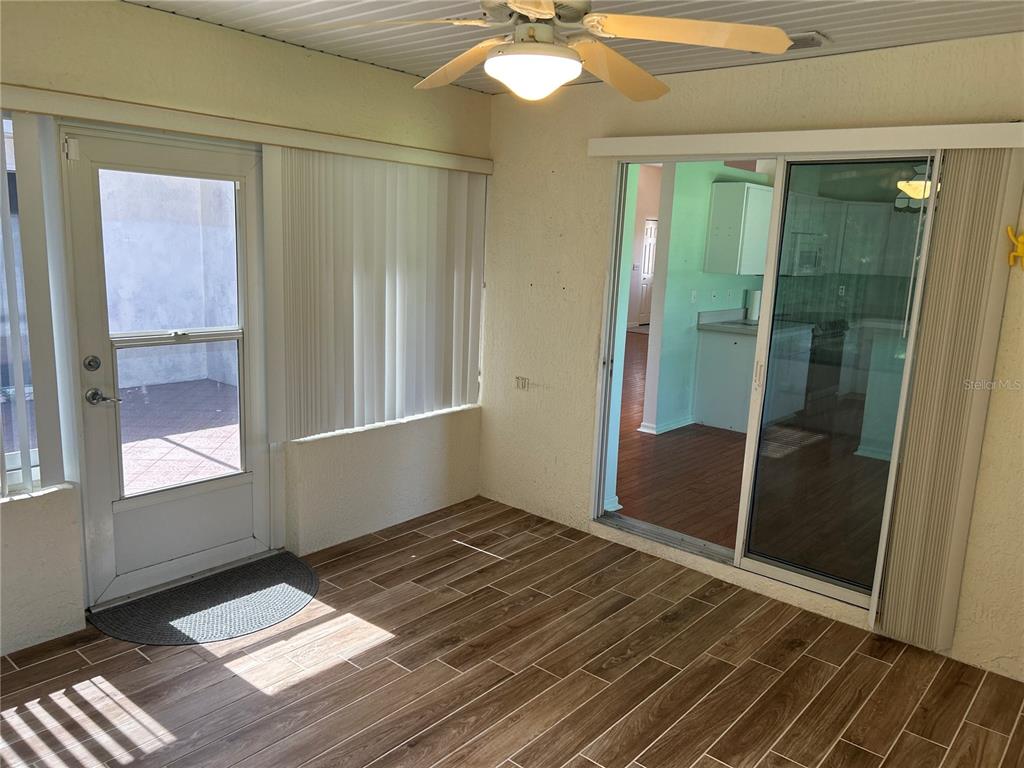 11014 Southwest 73rd Circle Ocala, FL 34476 - Photo 21 of 25 an empty room with wooden floor and windows