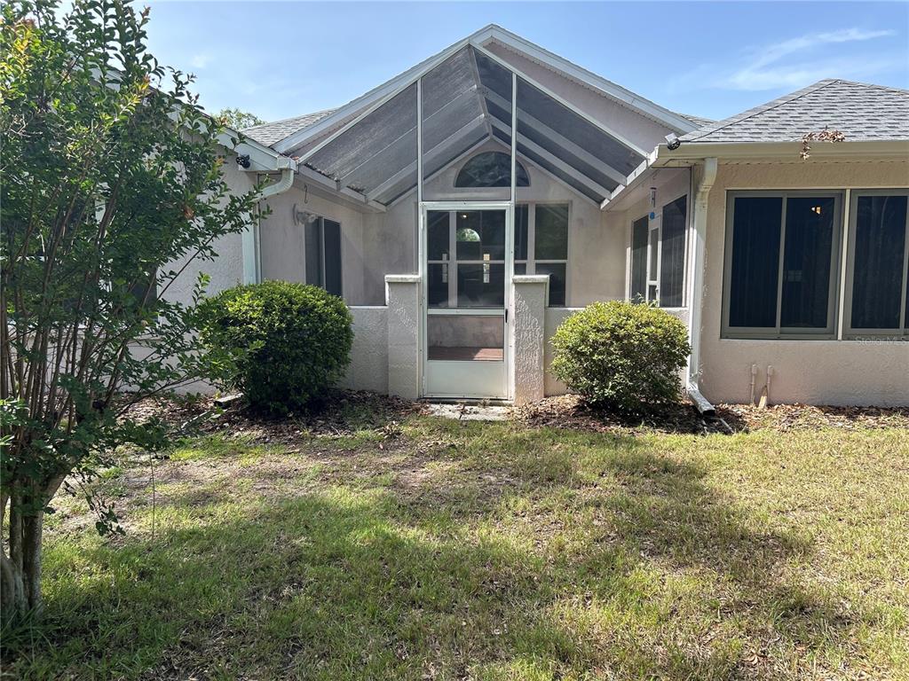 11014 Southwest 73rd Circle Ocala, FL 34476 - Photo 25 of 25 a front view of a house with a garden and plants