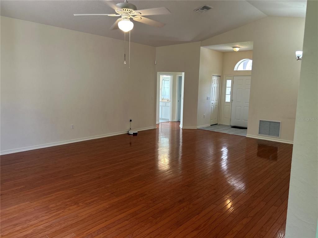 11014 Southwest 73rd Circle Ocala, FL 34476 - Photo 3 of 25 a view of a livingroom with wooden floor