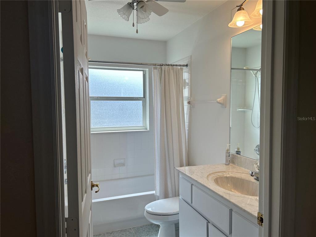 11014 Southwest 73rd Circle Ocala, FL 34476 - Photo 6 of 25 a bathroom with a sink a toilet and shower