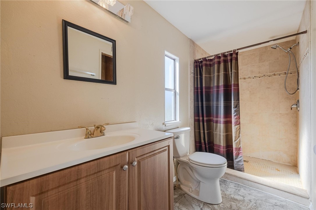 1315 Sunset Trail LaBelle, FL 33935 - Photo 10 of 23 a bathroom with a sink and a mirror