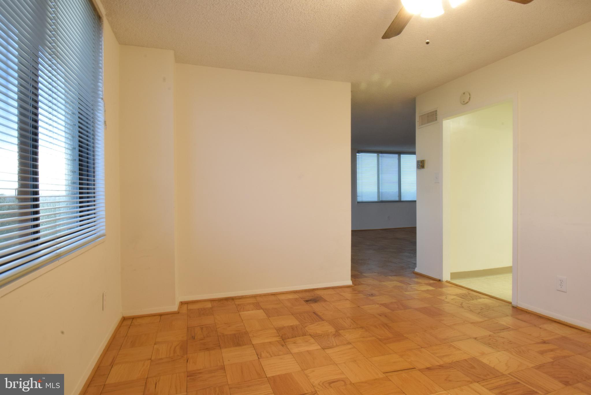 5225 Pooks Hill Road, Unit 1512N Bethesda, MD 20814 - Photo 9 of 26 a view of an empty room with window and chandelier fan