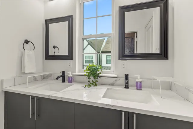 a bathroom with a sink vanity and a mirror