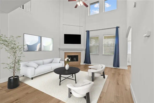 a living room with furniture a flat screen tv and a fireplace