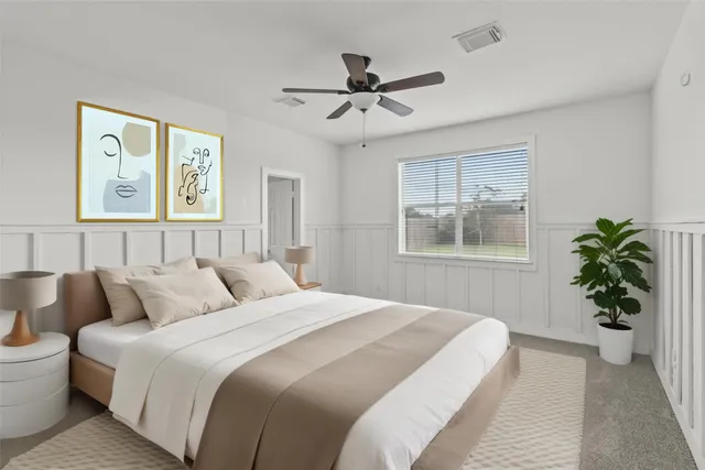 a bedroom with a large bed and a window