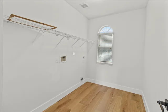 a view of a small space with wooden floor closet and windows