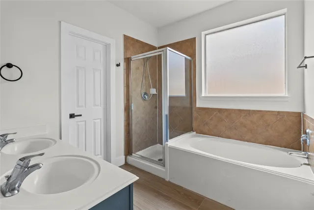 a bathroom with a tub and a sink