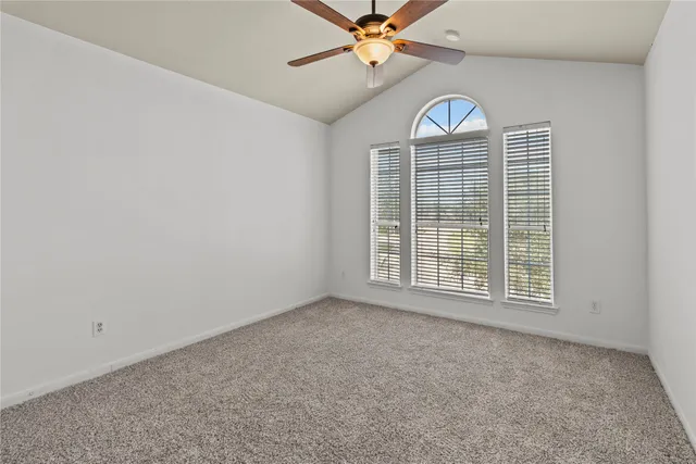 an empty room with a empty space and windows