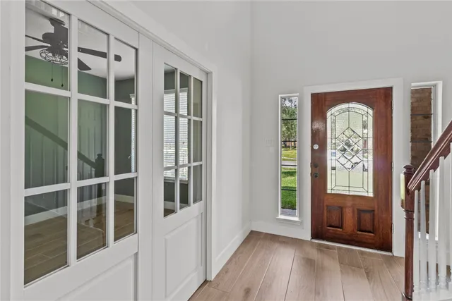 a view of front door of house with wooden floor