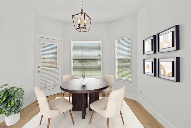 a view of a dining room with furniture window and wooden floor