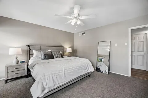 a bedroom with a bed and a chandelier
