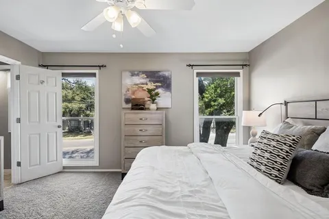 a bedroom with a bed and a window