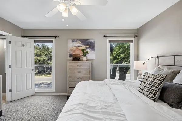 a bedroom with a bed and a chandelier