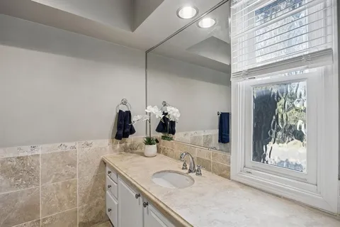 a bathroom with a double vanity sink and a mirror