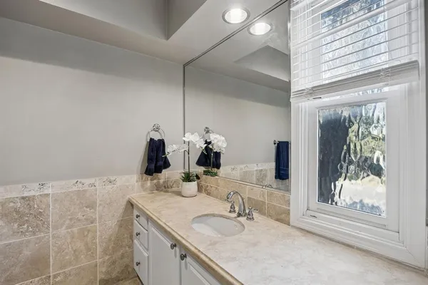 a bathroom with a shower and a mirror