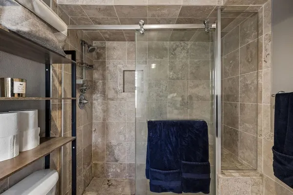 a bathroom with a granite countertop sink a large mirror a and next to a window