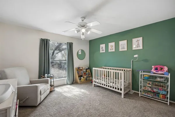 a room with furniture and a ceiling fan
